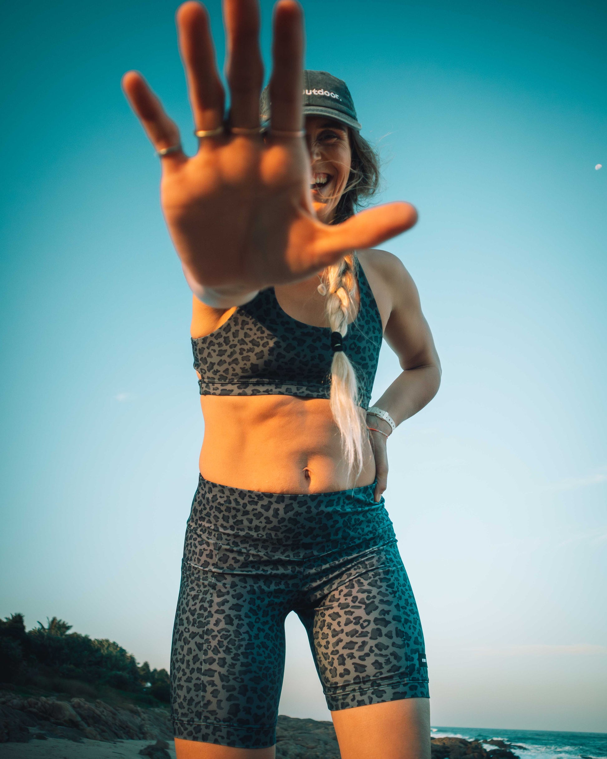 Woman in athletic wear with leopard print pattern on a beach